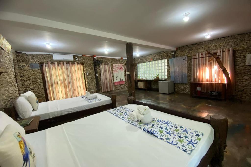 Postel nebo postele na pokoji v ubytování Oldwoods by the Sea Nature Resort Bani Pangasinan