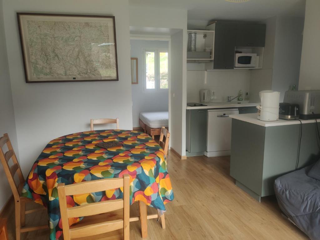 a room with a table and chairs and a kitchen at Clos saint michel in Luz-Saint-Sauveur
