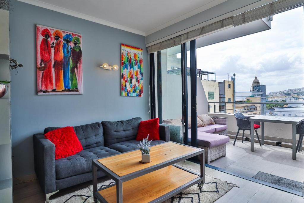 a living room with a couch and a table at Cape Town Condo J13 at The Adderley in Cape Town