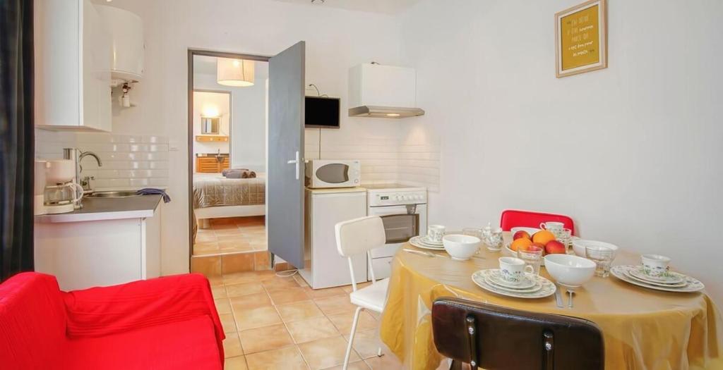 une cuisine et une salle à manger avec une table et des chaises dans l'établissement T2 dans le centre de Paramé, à Saint-Malo