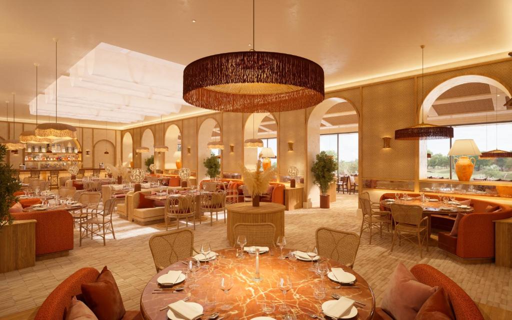 a restaurant with tables and chairs in a room at Hôtel Maison Chiberta I Ouverture été 2025 in Anglet