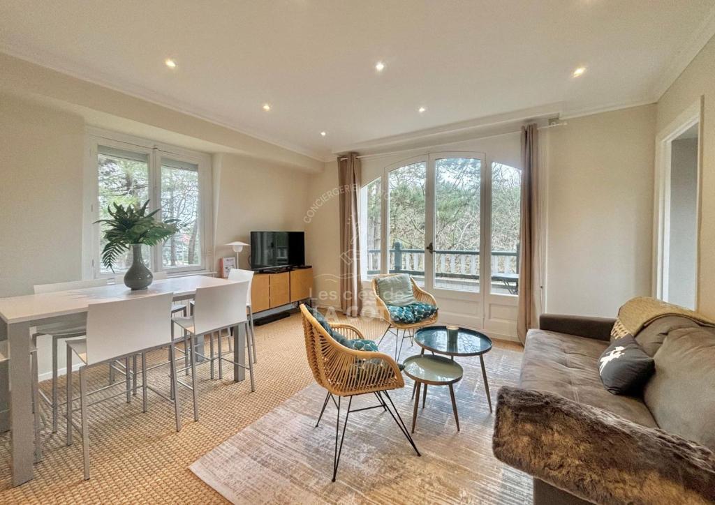 un salon avec un canapé et une table dans l'établissement Le Nid Touquettois, à Le Touquet-Paris-Plage