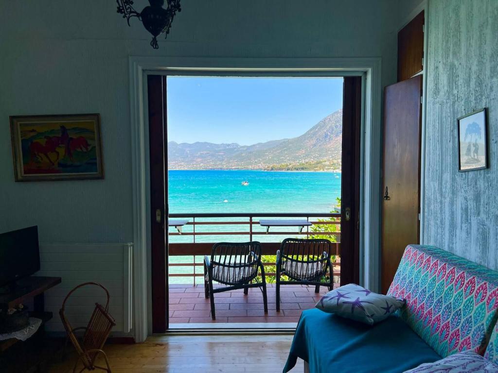 a living room with a view of the ocean from a door at 4BR by the Sea, Family friendly, Breathtaking View in Avia