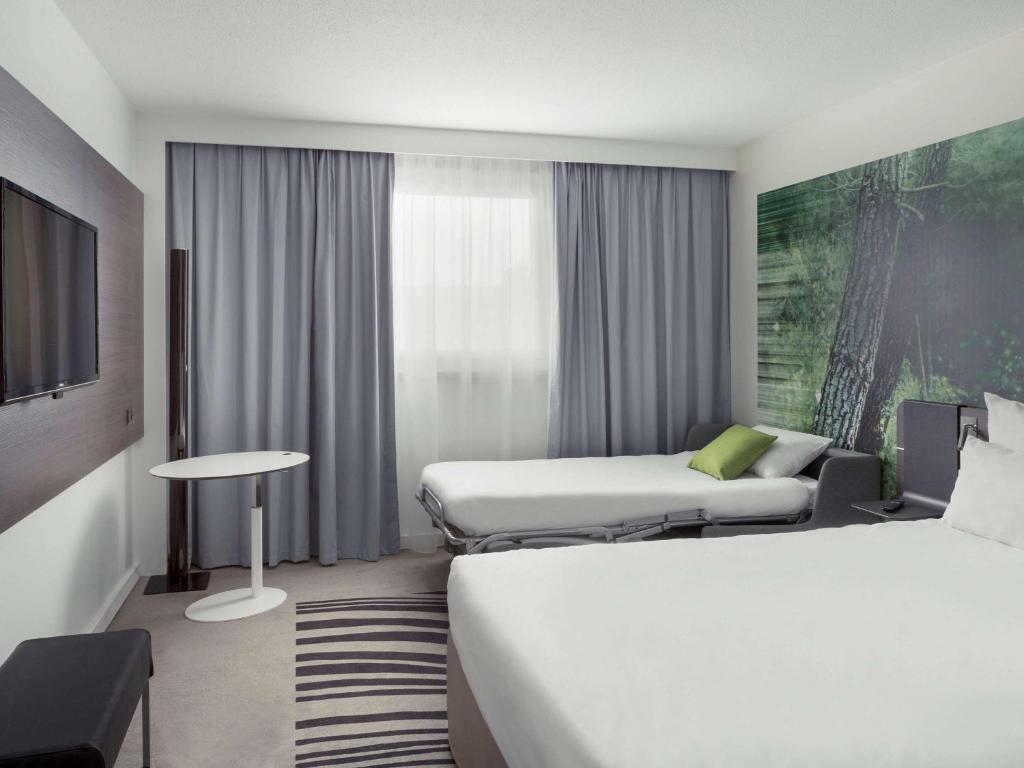 Postel nebo postele na pokoji v ubytování Novotel Paris Charles de Gaulle Airport