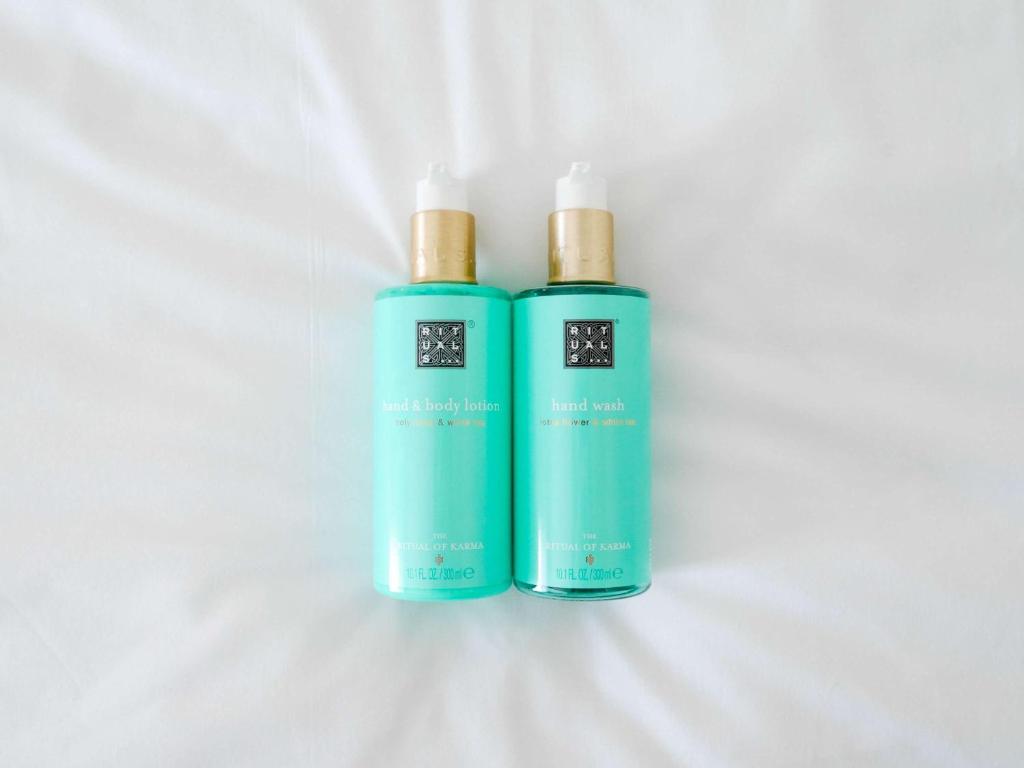 two green bottles ofodorizers sitting on a white background at Novotel Monte-Carlo in Monte Carlo