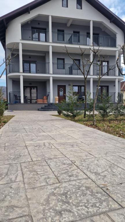 a large white building with a patio in front of it at Casa Joe in Râmnicu Vâlcea