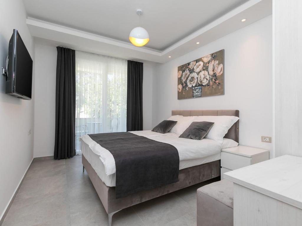 Łóżko lub łóżka w pokoju w obiekcie Nadija Apartmani
