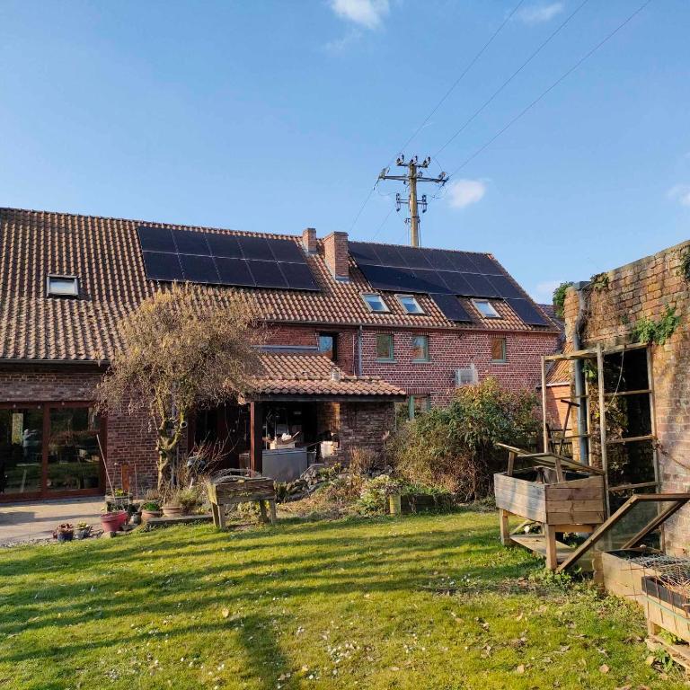 a house with solar panels on the roof at gite air pur in Roisin