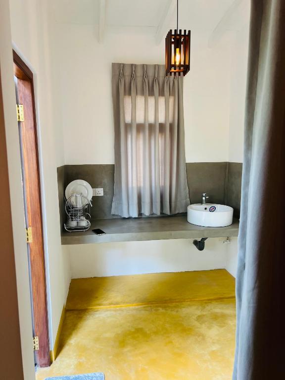 a bathroom with a sink and a window at Villa 66 Ahangama in Ahangama