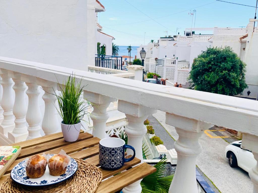 a table with a plate of pastries on a balcony at Casa Encanto de Nerja by At Home costa del sol in Nerja
