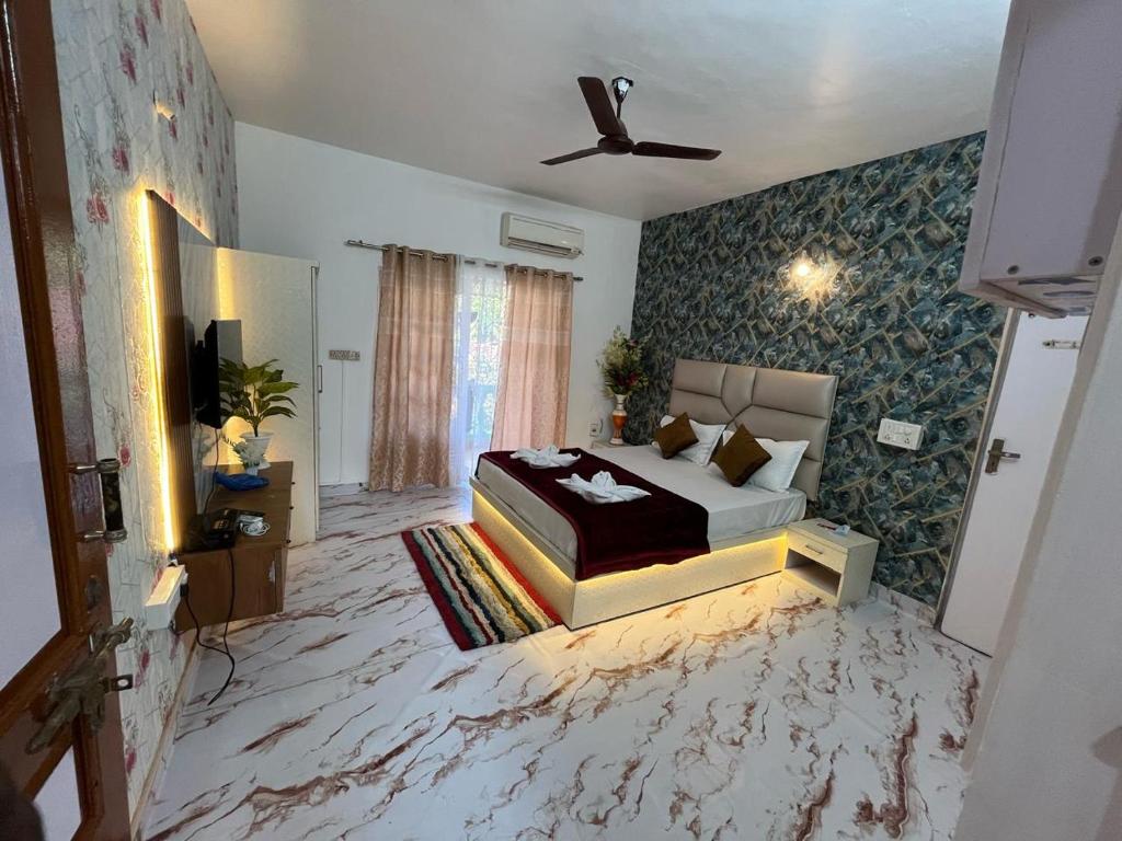 a bedroom with a bed and a tv in it at Dream Dwell Resort in Calangute