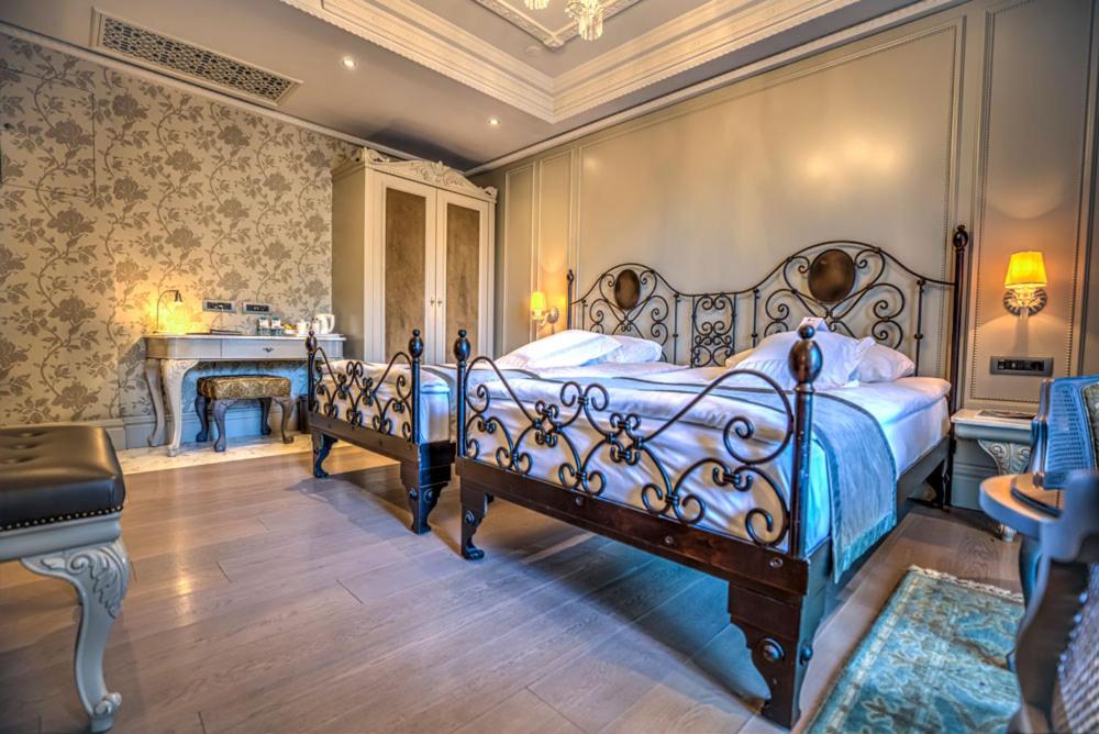 a bedroom with two beds and a desk in a room at MFB Tarabya Hotel in Istanbul