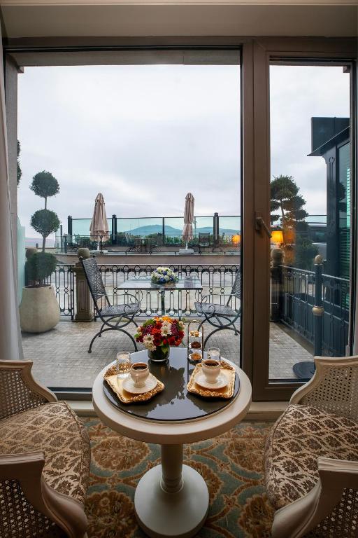 a table with food on it in front of a window at MFB Tarabya Hotel in Istanbul