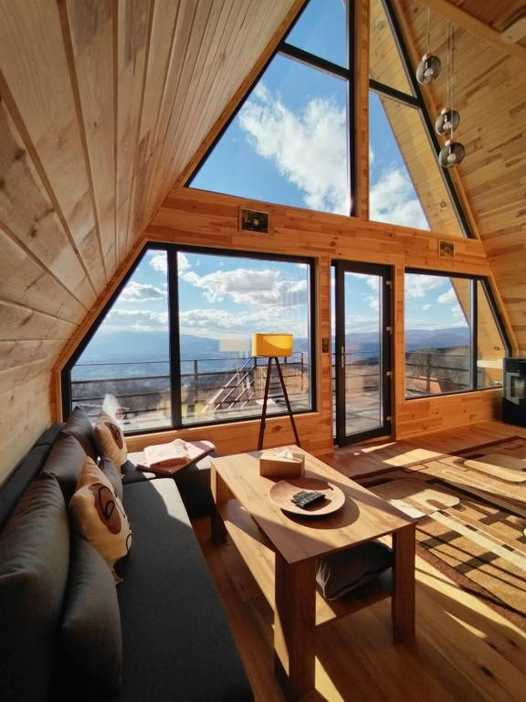 a living room with a couch and a table at Cez A-Frame in Petroşani
