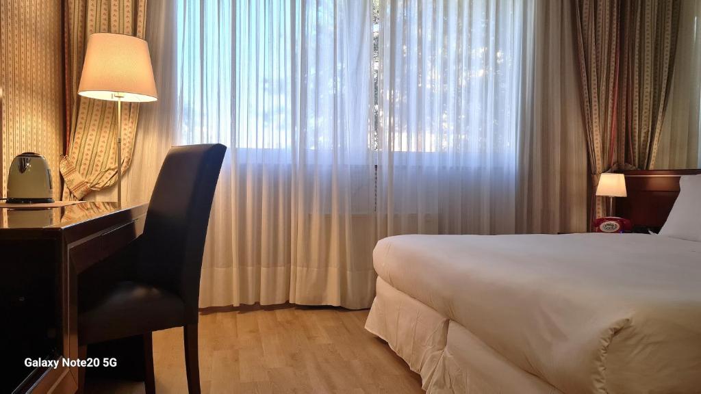 Postel nebo postele na pokoji v ubytování Garden Hotel Michelangelo