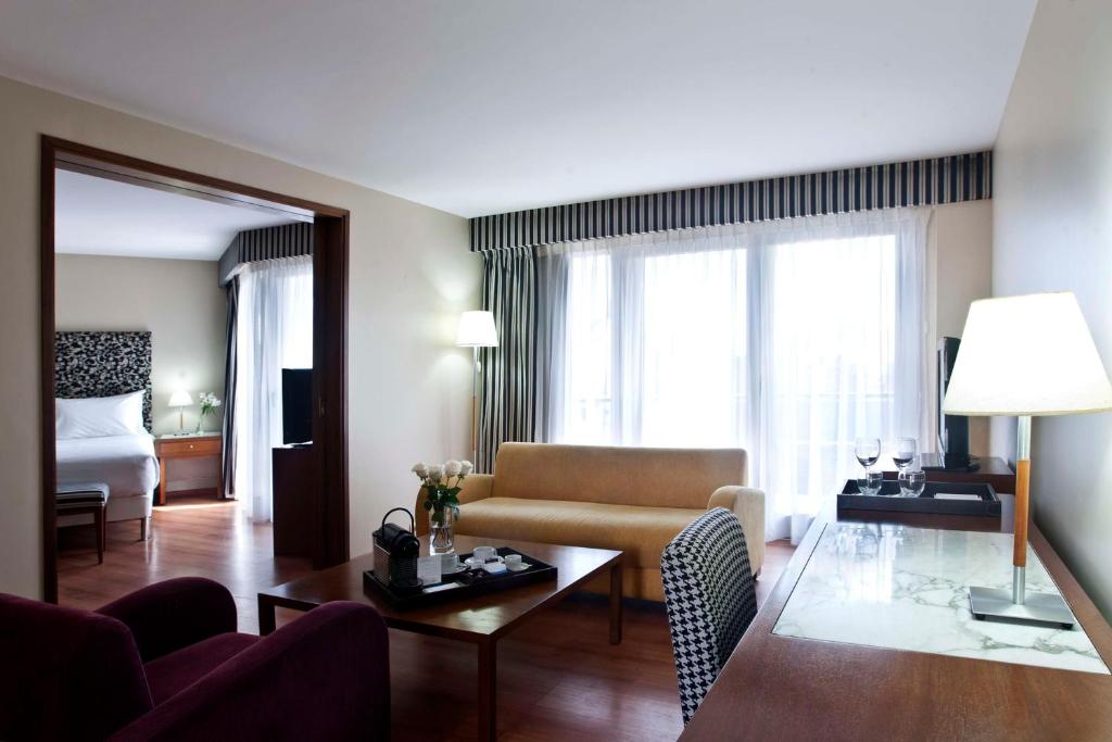 a living room with a couch and a table at NH Córdoba Panorama in Córdoba