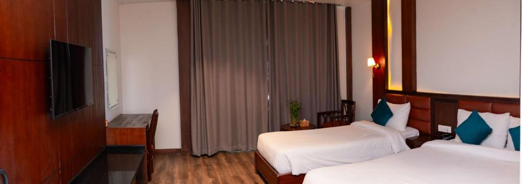 Postel nebo postele na pokoji v ubytování Galaxy Garden Resort