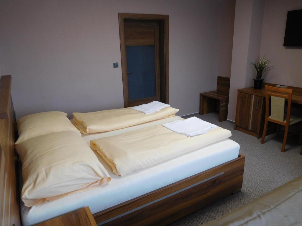 Postel nebo postele na pokoji v ubytování Hotel Panon