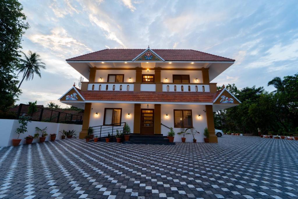 una casa con una entrada de ladrillo delante de ella en Treebo West Fort Divine - Near Padmanabhaswamy Temple, en Trivandrum