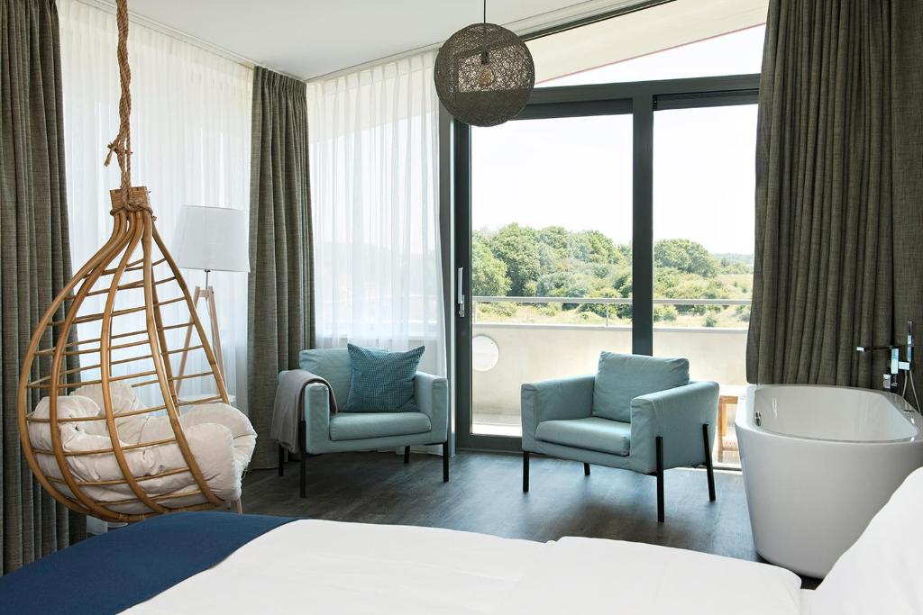 Postel nebo postele na pokoji v ubytování Strandhotel Duinoord