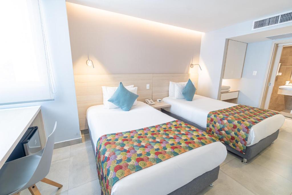 Postel nebo postele na pokoji v ubytování Hotel Barlovento