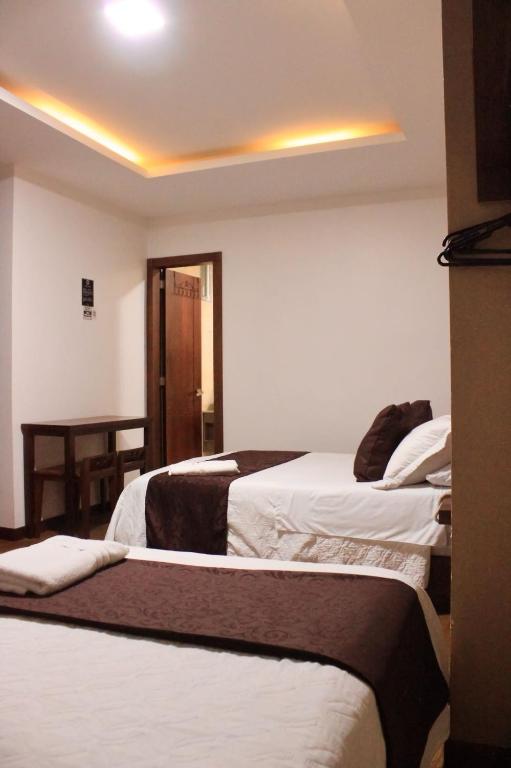 Postel nebo postele na pokoji v ubytování HOSTAL CAMIL