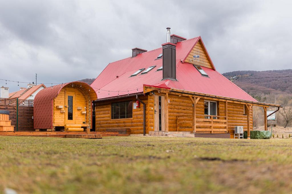 a log cabin with a red roof at Słoneczna Wetlina - Apartament 2 z kominkiem in Wetlina