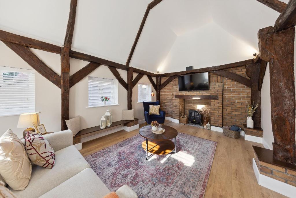 a living room with a couch and a fireplace at Charming cottage with hot tub & private garden in Rochester