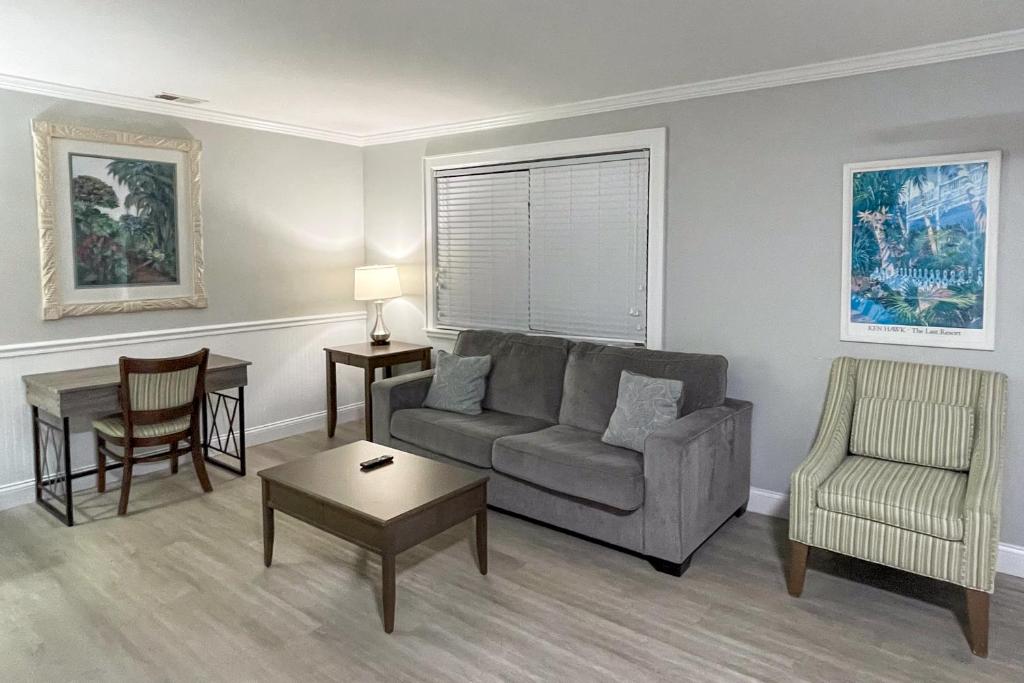 a living room with a couch and a chair at Marco Island Lakeside Inn in Marco Island