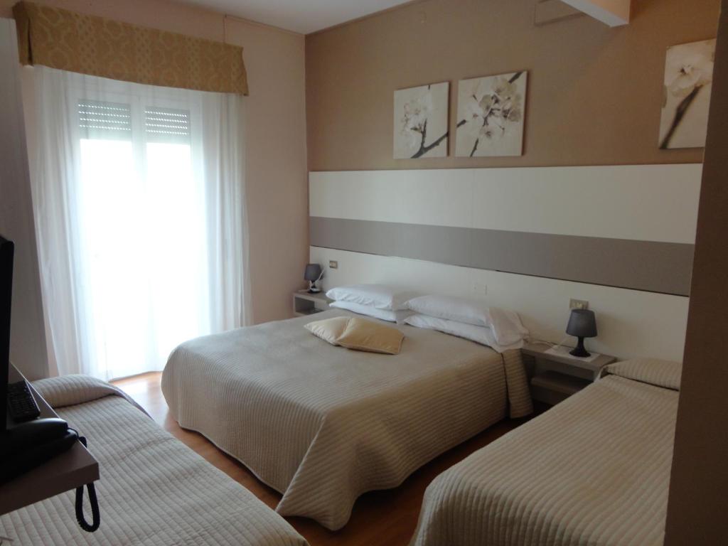 Postel nebo postele na pokoji v ubytování Hotel La Gioiosa