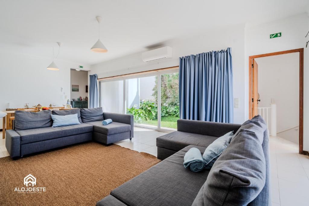 a living room with two couches and a couch at Ericeira Panoramic Sea View Apartments in Ericeira