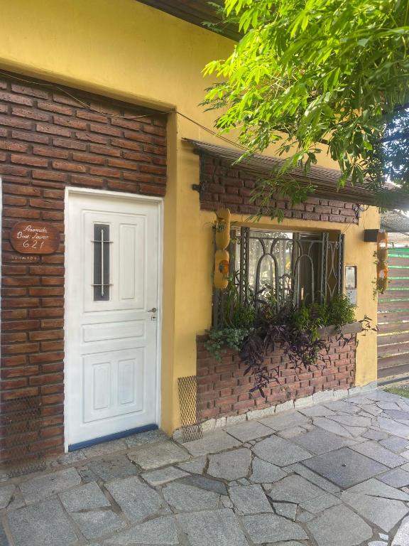 a white door on the side of a brick building at BelDaMar in Capilla del Monte