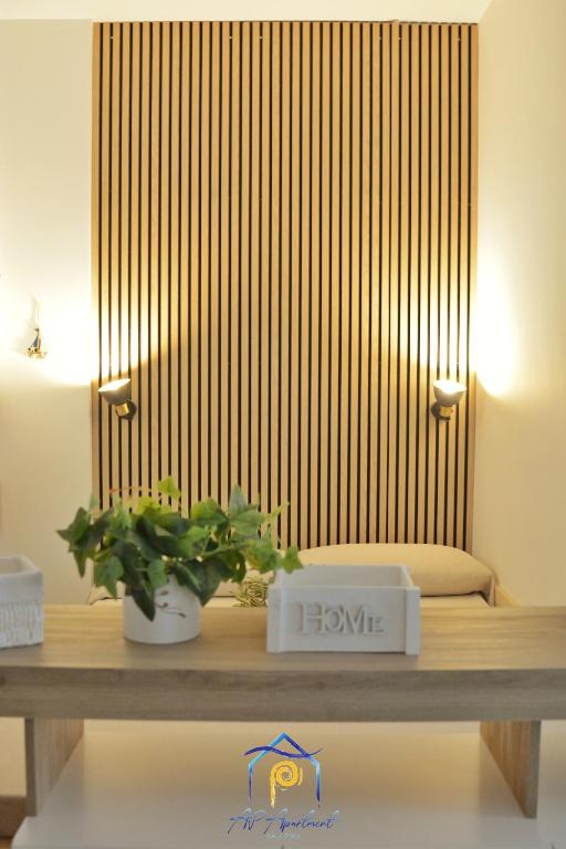 a table with a potted plant on top of it at Blu Celeste - by AP Apartment in Baia Verde