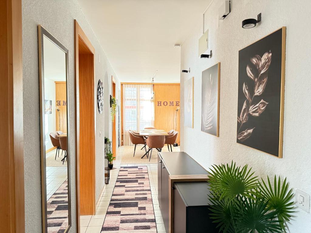 a hallway with a table and a dining room at Votre oasis au cœur de Lausanne in Lausanne