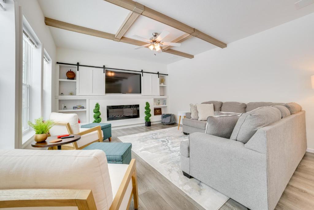 a living room with a couch and a tv at Walk to Beach Modern Retreat in Presque Isle! in Presque Isle