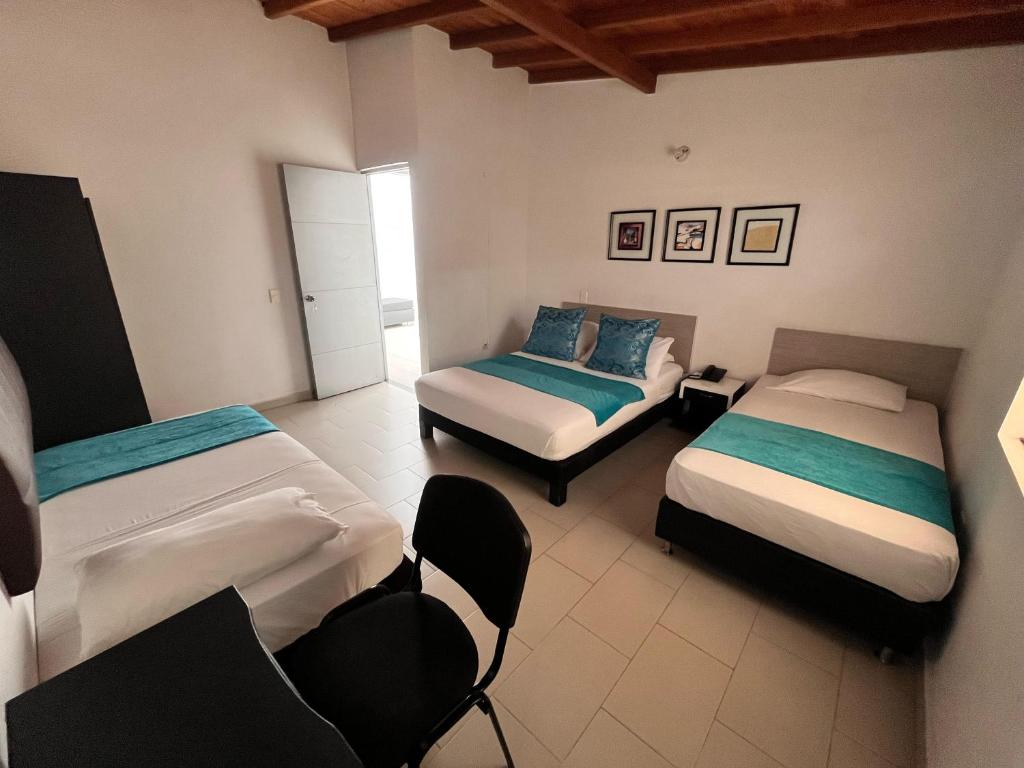 Postel nebo postele na pokoji v ubytování Hotel Quinta Avenida