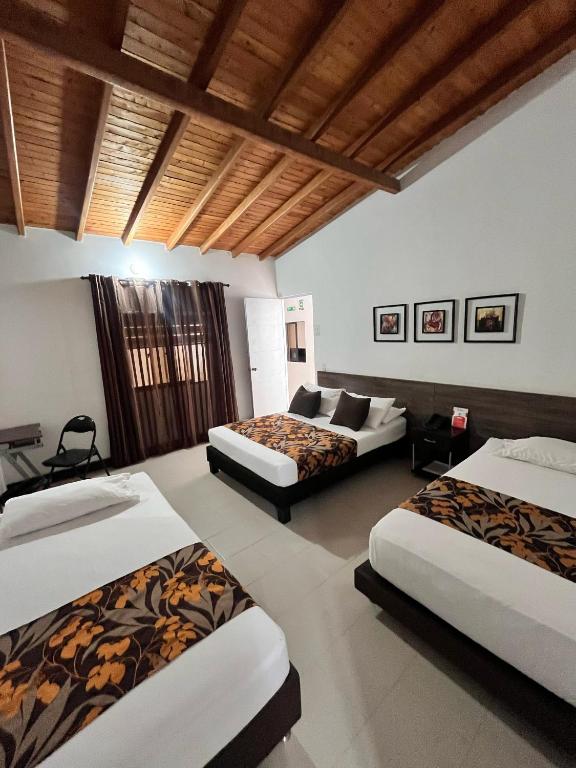 Postel nebo postele na pokoji v ubytování Hotel Quinta Avenida