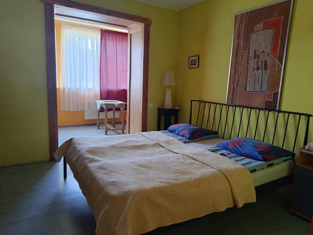 a bedroom with a large bed and a window at Sea Rooms ENGURE in Engure