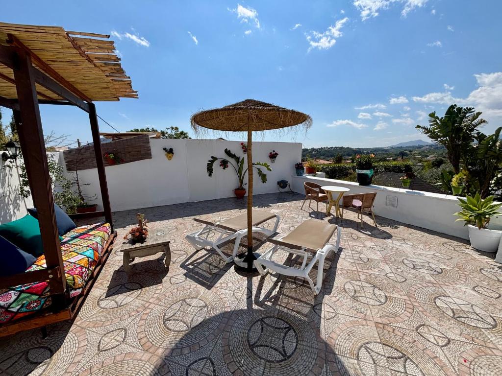 a patio with a table and chairs and an umbrella at Hotel Altea Paradise 1917 - Adults Only in Altea
