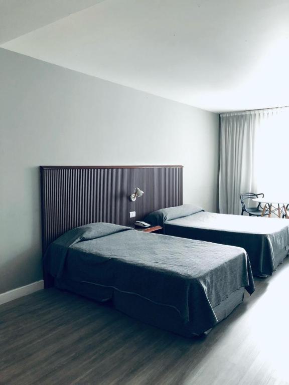 a bedroom with two beds and a window at Cristal Palace Hotel in Buenos Aires