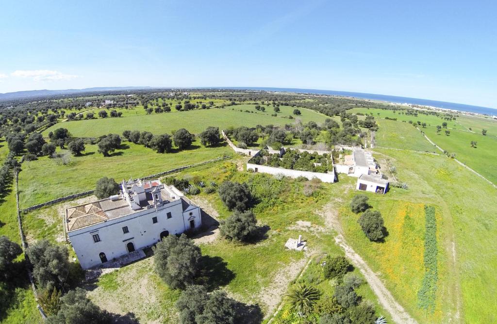 an aerial view of a large white building in a field at Masseria Palombara Grande in Ostuni