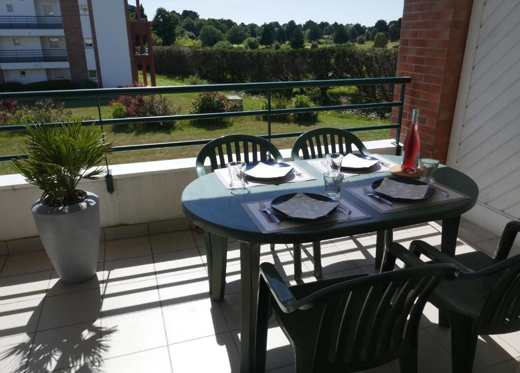 een blauwe tafel en stoelen op een balkon bij Le Green Set in Pornic