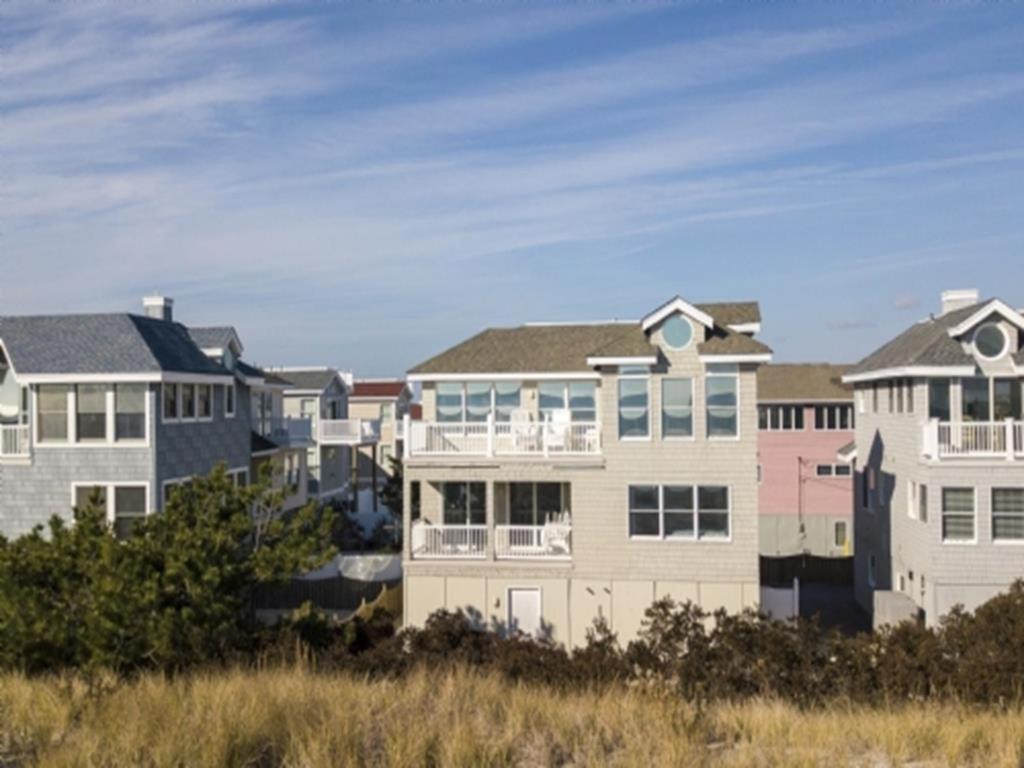 a row of houses on the beach at Ocean Front, Wi-Fi, Atlantic Views, 10 Beach Badges And Chairs, Outdoor Shower, Jacuzzi-Jet Tub, Decks Ping Pong Table, Private Yard,ship Bottom, in Ship Bottom