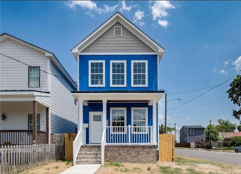 a blue and white house with a fence at Charming 3Bedroom Home in Vibrant Church Hill - Walk to Parks and Dining in Richmond