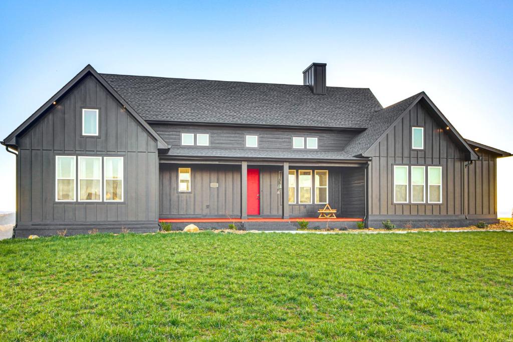 a large black house with a red door at Dale Hollow Lake Views and Hot Tub Tennessee Escape in Hilham