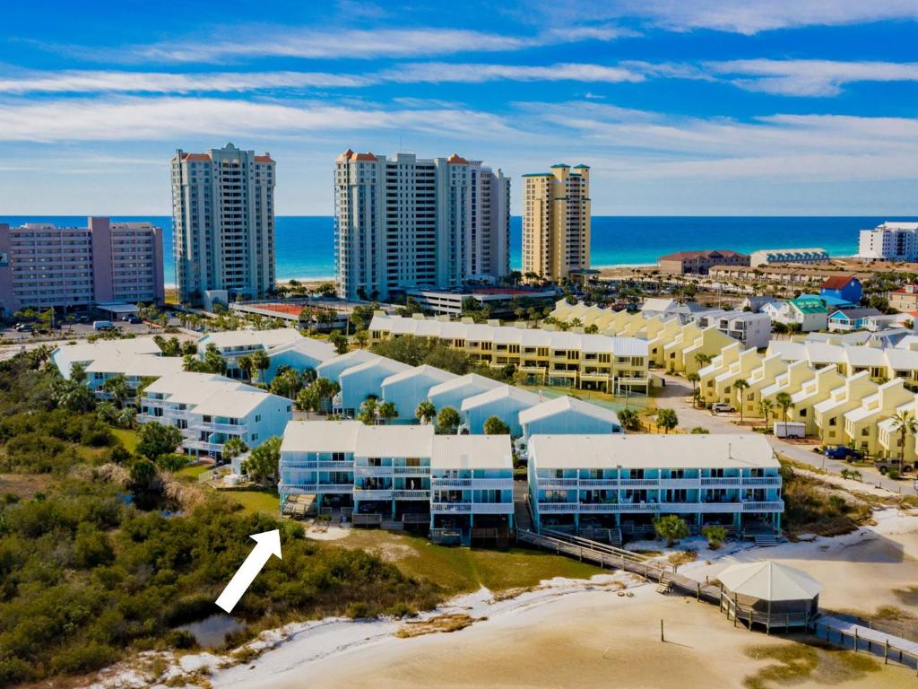 an aerial view of a city with buildings and the ocean at Sandcastle Townhomes #24 in Navarre