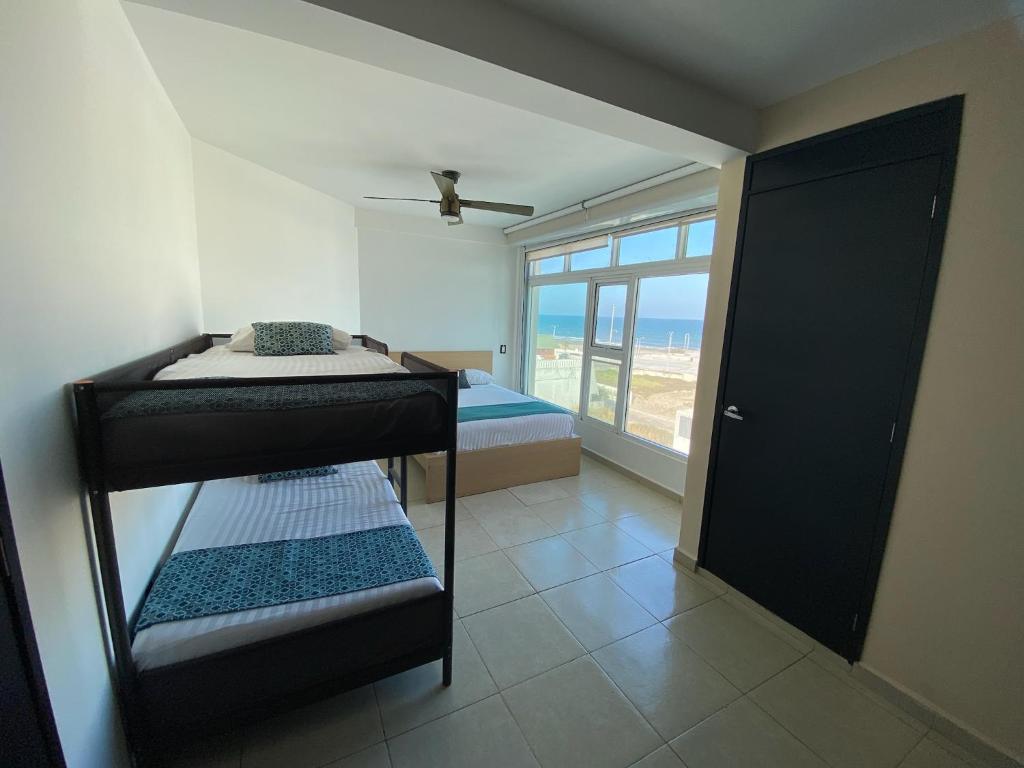Postel nebo postele na pokoji v ubytování FRENTE PLAYA vista al mar, PISCINA DE USO EXCLUSIVO