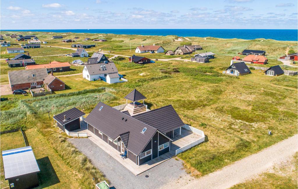 an aerial view of a home with the ocean in the background at Holiday Home Gloryvej Harboøre Iv in Harboør
