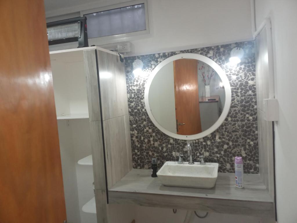 a bathroom with a sink and a mirror at Casa amoblada eventual in Villa Mercedes