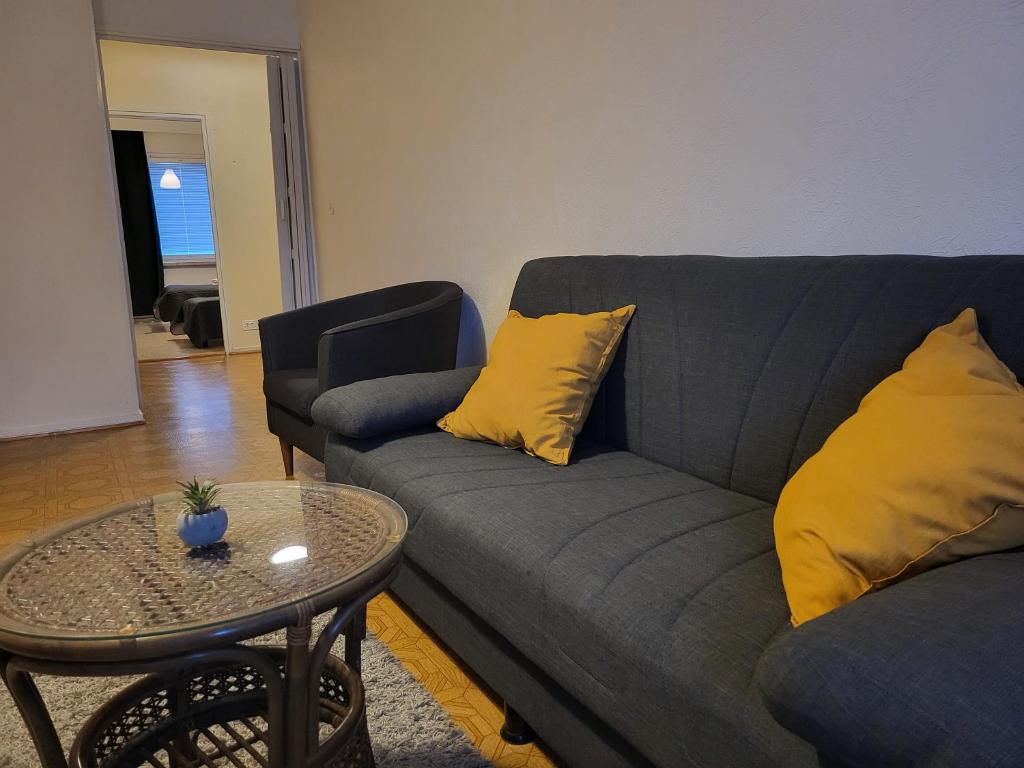 a living room with a couch and a table at Center apartment Joensuu in Joensuu